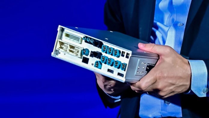 3.-Announcement-of-the-new-dGPU-Jack-Weast-holding-the-box-containing-CPU-dGPU-on-stage-copy.jpg